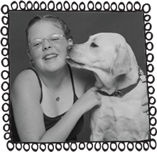 Black and white photo of Sammy Loewi, the author's daughter, as a child, being kissed by her dog. There is a fun illustration frame around the image made of hand drawn loops.